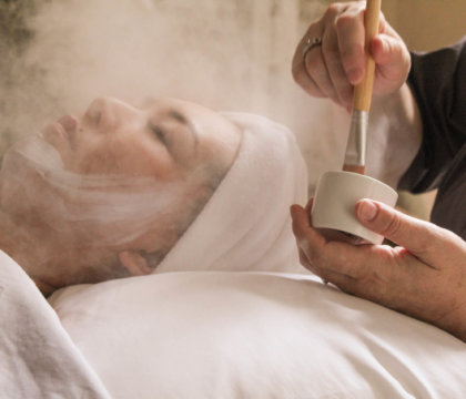 Woman receiving spa facial treatment