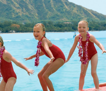 Three girls learning to surf in Waikiki