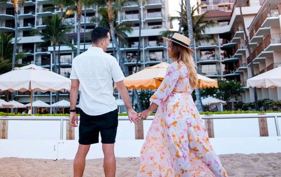 Couple on the beach in front of Halekulani