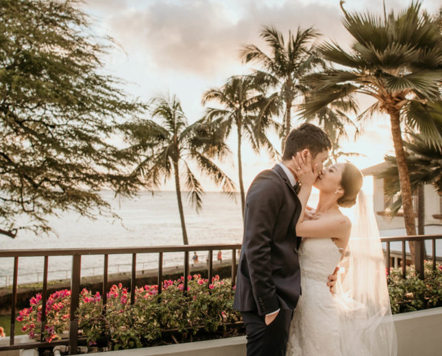 Wedding couple share a kiss at sunset