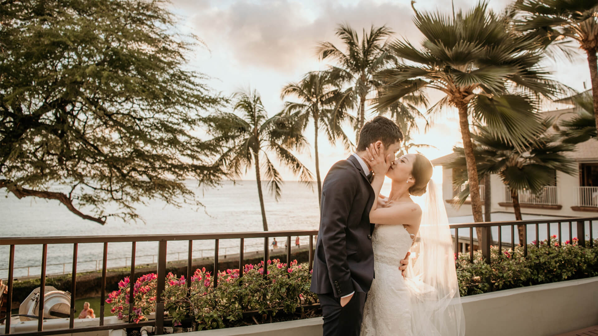 Wedding couple share a kiss at sunset